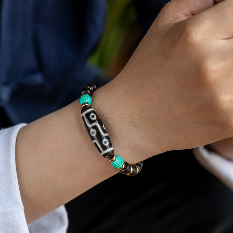 The Agate and Dzi Bead Protection Bracelet as worn on the wrist, demonstrating its fit and fashion alongside its protective qualities.