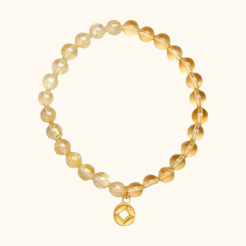 Sparkling citrine bracelet with a gold charm, crafted to attract joy and prosperity.