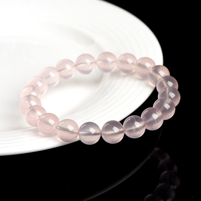 Close-up of the smooth and soothing rose quartz beads, showcasing their clarity and delicate pink tones that promote emotional healing and love.