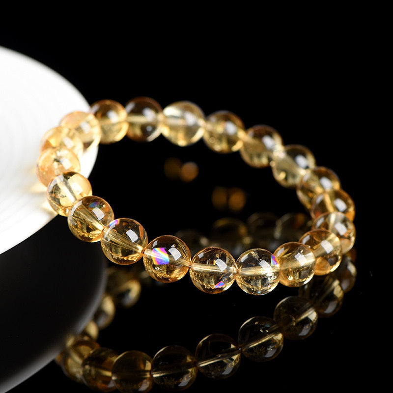 A circle of polished golden citrine beads, designed to enhance prosperity and positive energy.