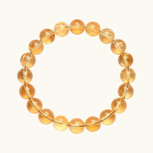 A circle of polished golden citrine beads, designed to enhance prosperity and positive energy.