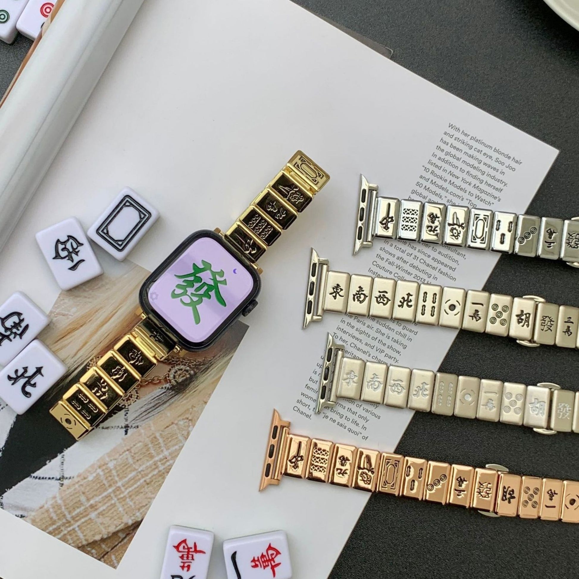 Mahjong-inspired Apple Watch bands in gold, silver, and rose gold, featuring intricate tile designs and luxurious finish.